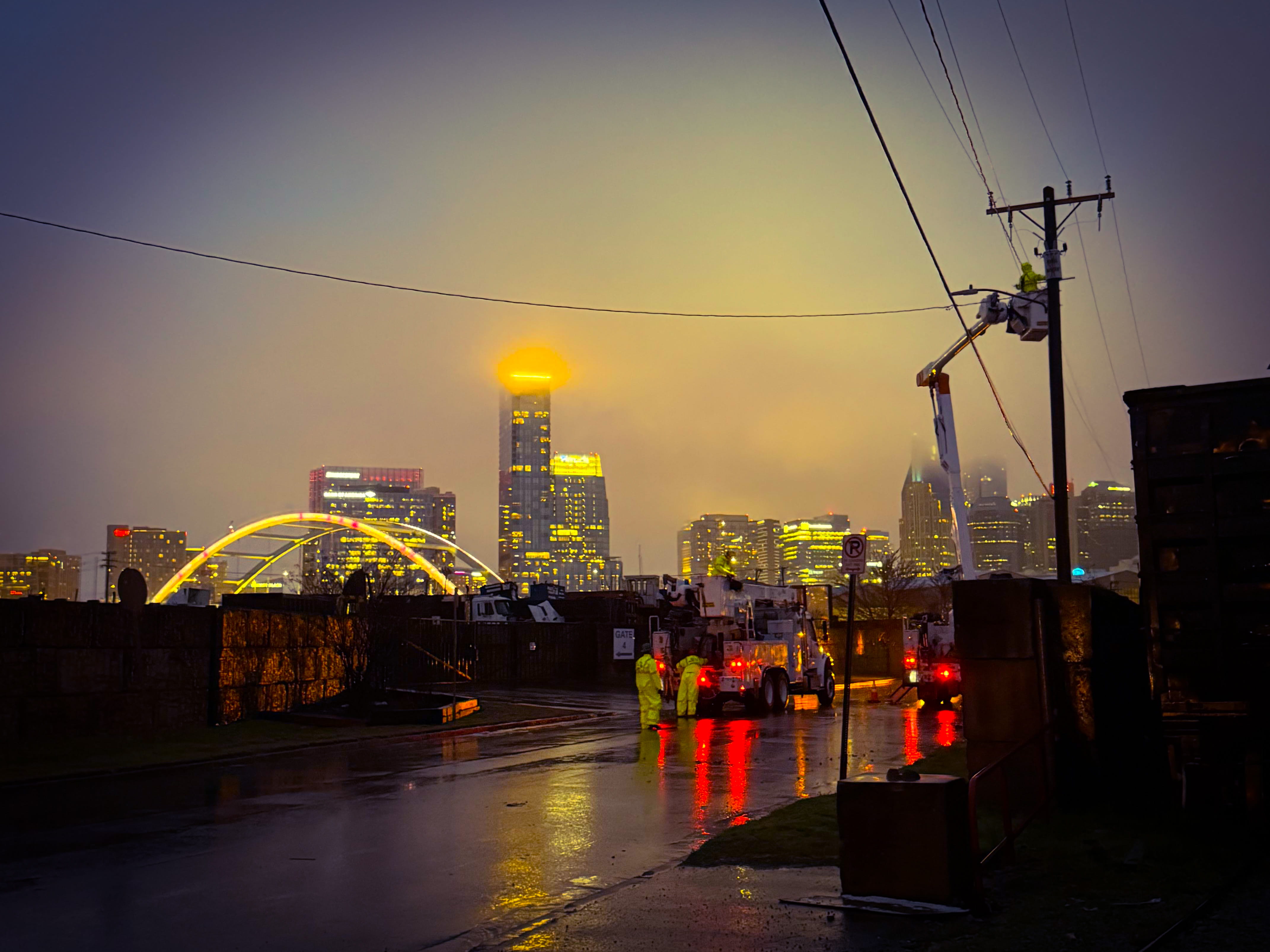 Picture of the Nashville skyline and lineworkers repairing an outage.